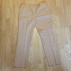 A salmon light pink, beige, professional khaki pants.